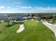 Aerial view of a golf course with putting green near clubhouse at 10820 Trophy Dr, Englewood, FL 34223