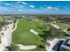 Aerial view of a beautiful golf course with sand traps and palm trees at 10820 Trophy Dr, Englewood, FL 34223