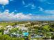 Aerial view of community, showcasing homes, pool, and lush landscape at 10820 Trophy Dr, Englewood, FL 34223