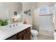 Bathroom with tub shower combination and dark wood vanity at 10820 Trophy Dr, Englewood, FL 34223