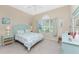 Light and airy bedroom with a queen-size bed and light blue accents at 10820 Trophy Dr, Englewood, FL 34223