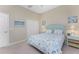 Guest bedroom with light teal headboard and seashell bedding at 10820 Trophy Dr, Englewood, FL 34223