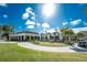 Exterior of clubhouse with patio seating and golf cart at 10820 Trophy Dr, Englewood, FL 34223