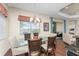 Casual dining area with glass table and four chairs, near kitchen at 10820 Trophy Dr, Englewood, FL 34223