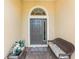 Inviting entryway with a bench and potted plants at 10820 Trophy Dr, Englewood, FL 34223