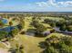 Aerial view of championship golf course with water features at 10820 Trophy Dr, Englewood, FL 34223