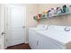 Laundry room with washer, dryer, and shelving for storage at 10820 Trophy Dr, Englewood, FL 34223