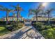 Entrance to resort-style pool with lush landscaping at 10820 Trophy Dr, Englewood, FL 34223