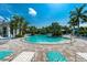 Relaxing resort-style pool with lounge chairs and lush landscaping at 10820 Trophy Dr, Englewood, FL 34223