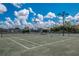 Well-maintained tennis courts with seating area at 10820 Trophy Dr, Englewood, FL 34223