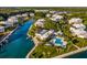 Aerial view of waterfront community with pool, lush landscaping, and boat docks at 11000 Placida Rd # 201, Placida, FL 33946