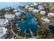 Aerial view showcasing a waterfront community with private boat docks and a central pool at 11000 Placida Rd # 201, Placida, FL 33946