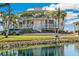 Exterior of two-story home with balconies, palm trees, and waterfront views at 11000 Placida Rd # 201, Placida, FL 33946