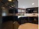 Modern kitchen with black cabinets and stainless steel appliances at 11000 Placida Rd # 201, Placida, FL 33946