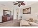 Bedroom with dresser, chaise lounge, and ceiling fan at 117 Cable Dr, Rotonda West, FL 33947