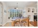 Breakfast nook features a wooden table, window seating, and white shutters at 117 Cable Dr, Rotonda West, FL 33947