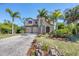 Two-story house with stone accents and palm trees at 117 Cable Dr, Rotonda West, FL 33947