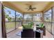 Relaxing screened lanai with wicker furniture and wood flooring at 117 Cable Dr, Rotonda West, FL 33947