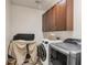 Laundry room with washer, dryer, and upper cabinets at 117 Cable Dr, Rotonda West, FL 33947