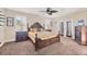 Main bedroom with a king-size bed, ceiling fan and plantation shutters at 117 Cable Dr, Rotonda West, FL 33947