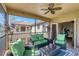 Relaxing screened balcony with seating area, ceiling fan, and view of surrounding buildings at 117 Cable Dr, Rotonda West, FL 33947