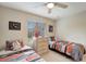 Well-lit bedroom featuring twin beds, dresser, and window coverings at 13235 Essman Ave, Port Charlotte, FL 33953