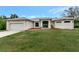 Single-story home with attached garage and well-manicured lawn at 13235 Essman Ave, Port Charlotte, FL 33953