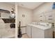 Laundry room with washer, dryer, and ample shelving at 13235 Essman Ave, Port Charlotte, FL 33953