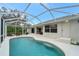 Relaxing screened pool and patio with lounge chairs at 13235 Essman Ave, Port Charlotte, FL 33953