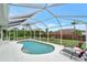 Relaxing pool area with screened enclosure and lounge chairs at 13235 Essman Ave, Port Charlotte, FL 33953