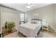 Comfortable bedroom with a queen-size bed and ceiling fan at 13575 Chenille Dr, Port Charlotte, FL 33981