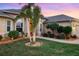 Landscaped front yard with a charming walkway and lighting at 13575 Chenille Dr, Port Charlotte, FL 33981