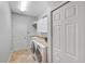 Laundry room with washer, dryer, storage cabinets and a sink at 13575 Chenille Dr, Port Charlotte, FL 33981