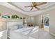 Main bedroom with white platform bed and sliding glass doors to pool area at 13575 Chenille Dr, Port Charlotte, FL 33981