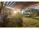 Relaxing pergola covered in lush greenery, perfect for outdoor enjoyment at 13575 Chenille Dr, Port Charlotte, FL 33981