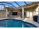 Inviting pool area with covered patio, outdoor furniture, and grill at 13575 Chenille Dr, Port Charlotte, FL 33981