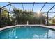 Relaxing pool with a surrounding patio for lounging and entertaining at 13575 Chenille Dr, Port Charlotte, FL 33981