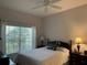 Charming bedroom with a full-size bed, window seating and two nightstands at 1415 Winding Oak Dr, Port Charlotte, FL 33948