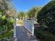 White footbridge leading through lush landscaping at 1415 Winding Oak Dr, Port Charlotte, FL 33948