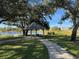 Relaxing gazebo overlooking a lake, perfect for enjoying the outdoors at 1415 Winding Oak Dr, Port Charlotte, FL 33948