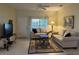 Comfortable living room featuring neutral-toned furniture and a large window at 1415 Winding Oak Dr, Port Charlotte, FL 33948