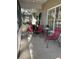 Relaxing screened porch with seating area and view of landscaped yard at 1415 Winding Oak Dr, Port Charlotte, FL 33948