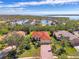 House with red tile roof, near the waterfront with a golf cart at 14173 Myakka Pointe Dr, Port Charlotte, FL 33953