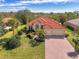 Attractive single-story home with tile roof, lush landscaping, and brick driveway at 14173 Myakka Pointe Dr, Port Charlotte, FL 33953