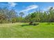 Landscaped backyard with lush grass and tropical plants at 14173 Myakka Pointe Dr, Port Charlotte, FL 33953