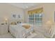 Bedroom with a queen bed, window, and neutral decor at 14173 Myakka Pointe Dr, Port Charlotte, FL 33953