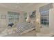 Bright bedroom with striped bedding and access to backyard at 14173 Myakka Pointe Dr, Port Charlotte, FL 33953