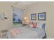 Bright bedroom with a queen-size bed and beach themed decor at 14173 Myakka Pointe Dr, Port Charlotte, FL 33953