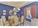 Formal dining room with dark wood table and blue walls at 14173 Myakka Pointe Dr, Port Charlotte, FL 33953