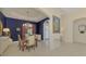 Formal dining room with dark wood table and blue walls at 14173 Myakka Pointe Dr, Port Charlotte, FL 33953